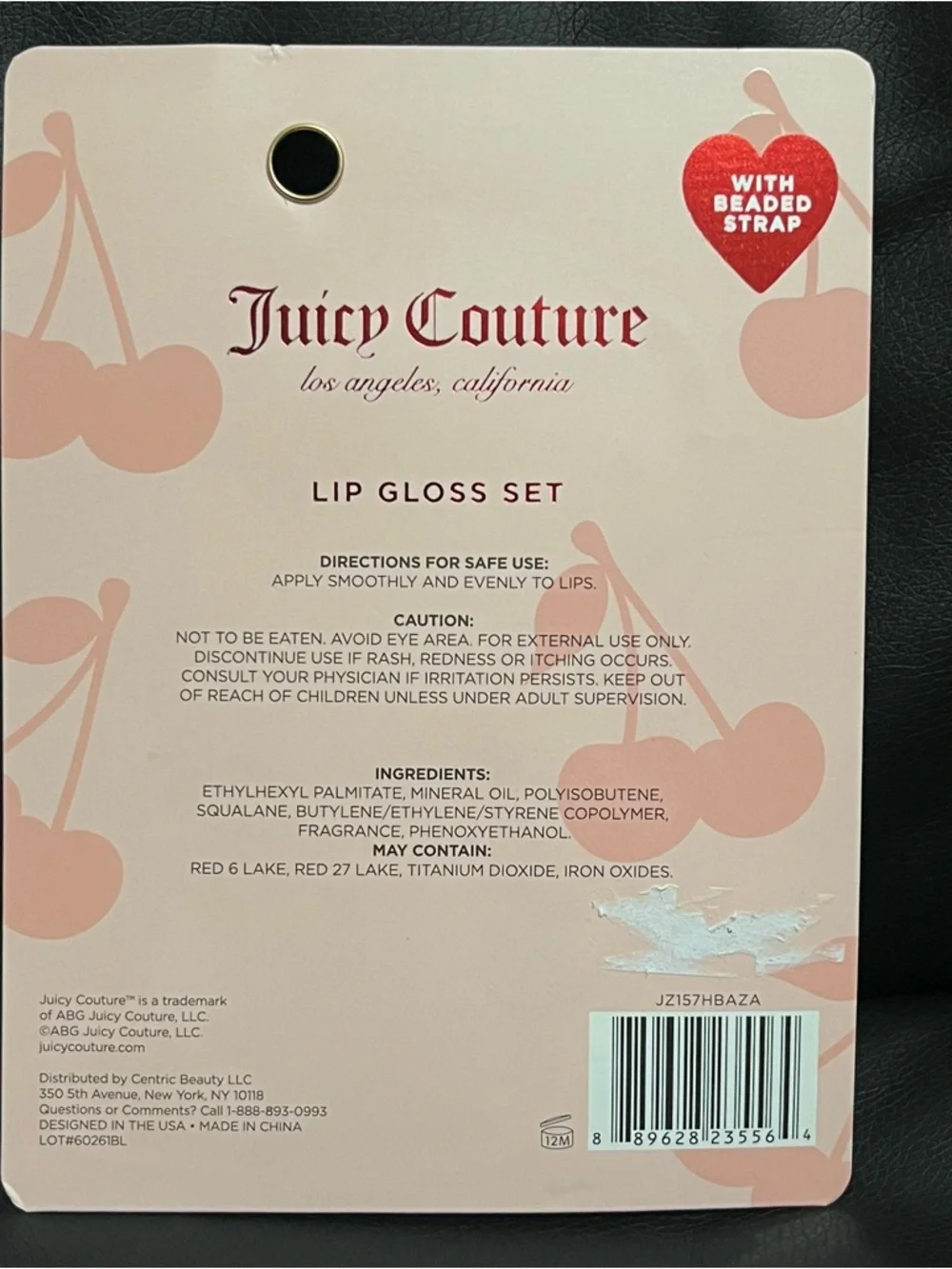 Juicy Couture lip gloss set that includes a beaded cherry keychain